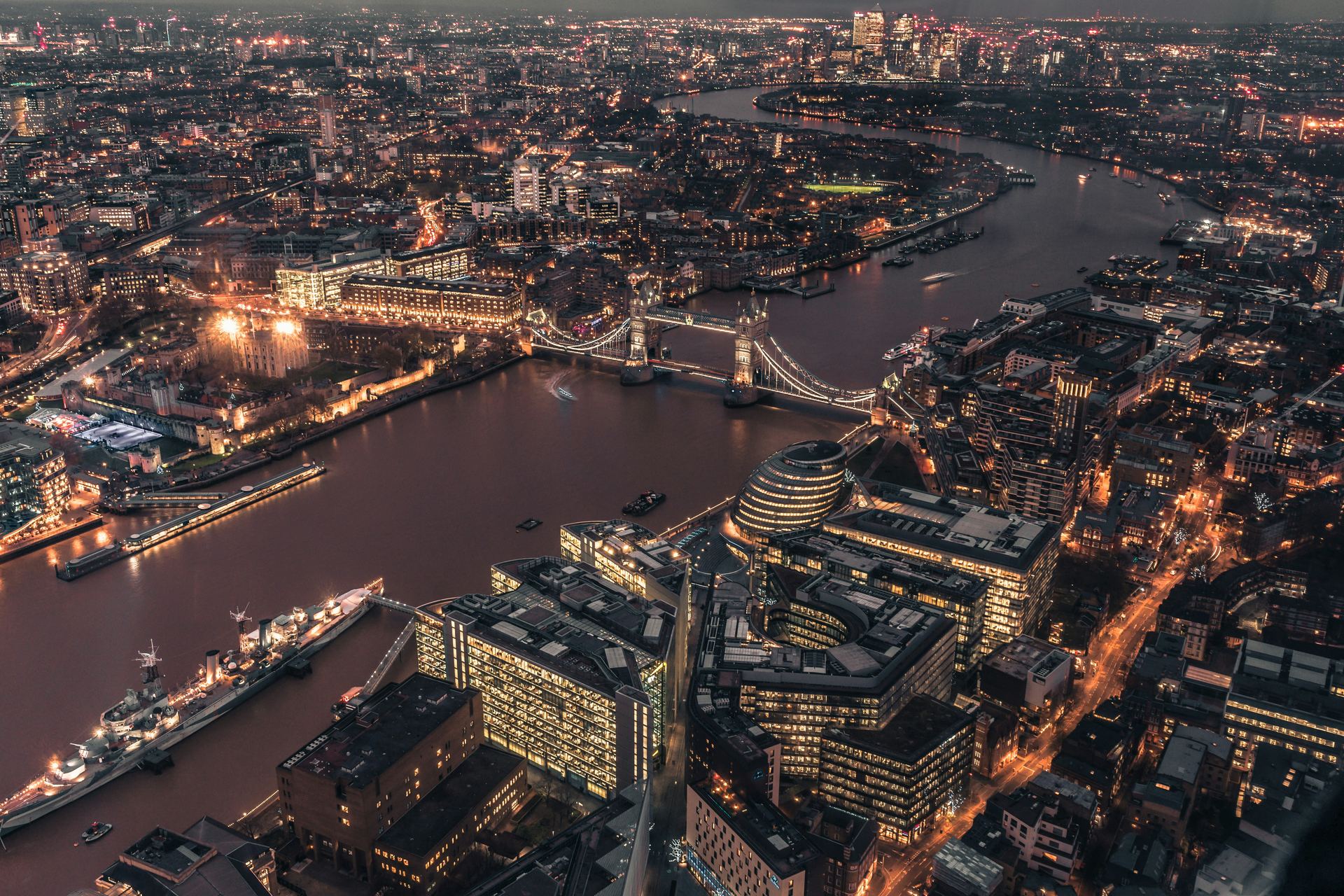 London at night from above, Tower Bridge lit on the Thames